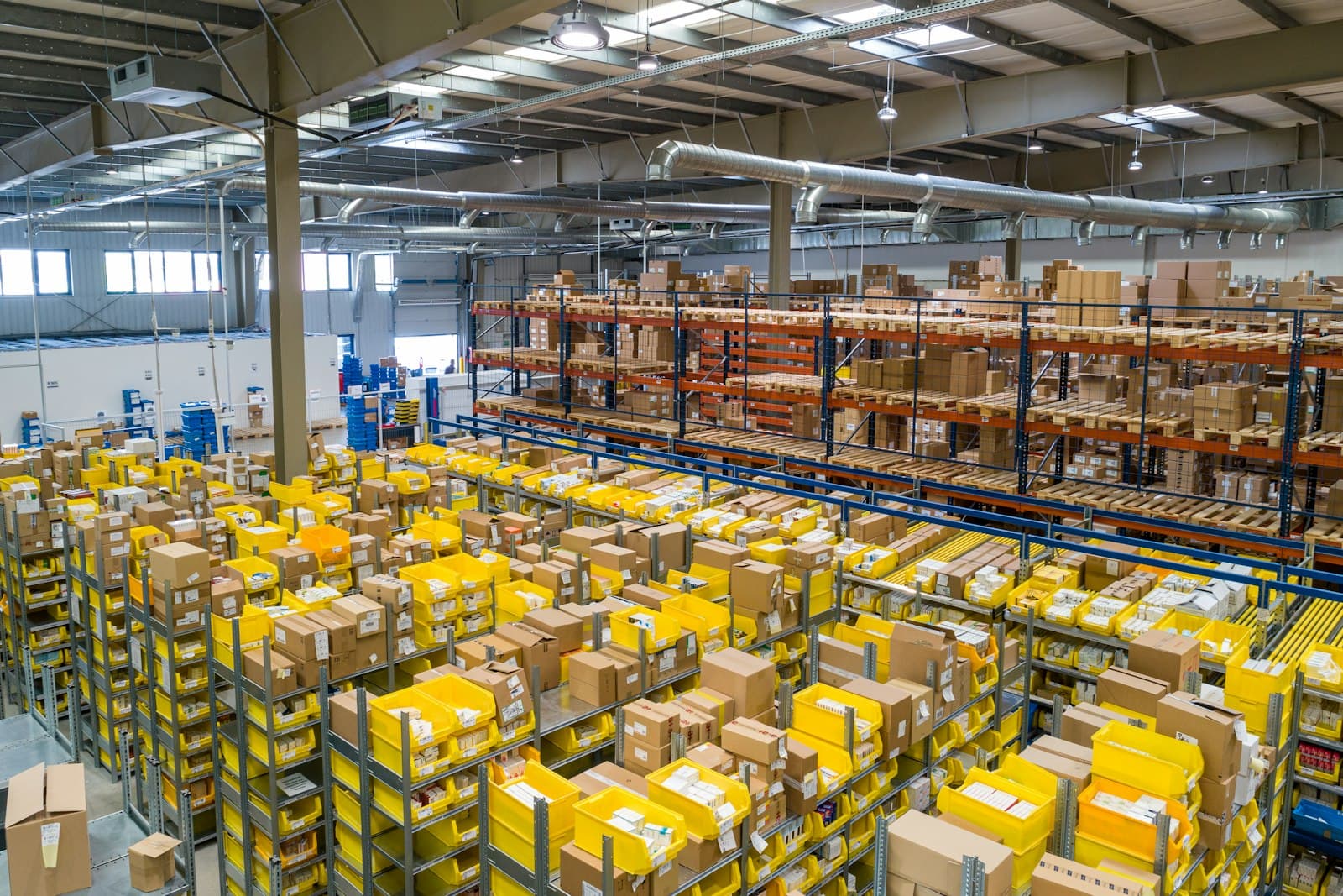 Air cargo being handled on a warehouse floor beside freight equipment.